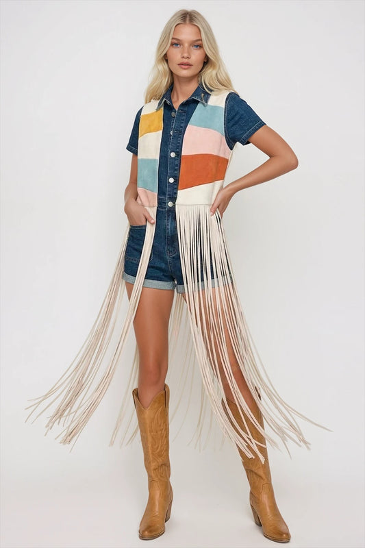 Front view of the colorblock faux suede fringe vest layered over a denim romper and cowboy boots