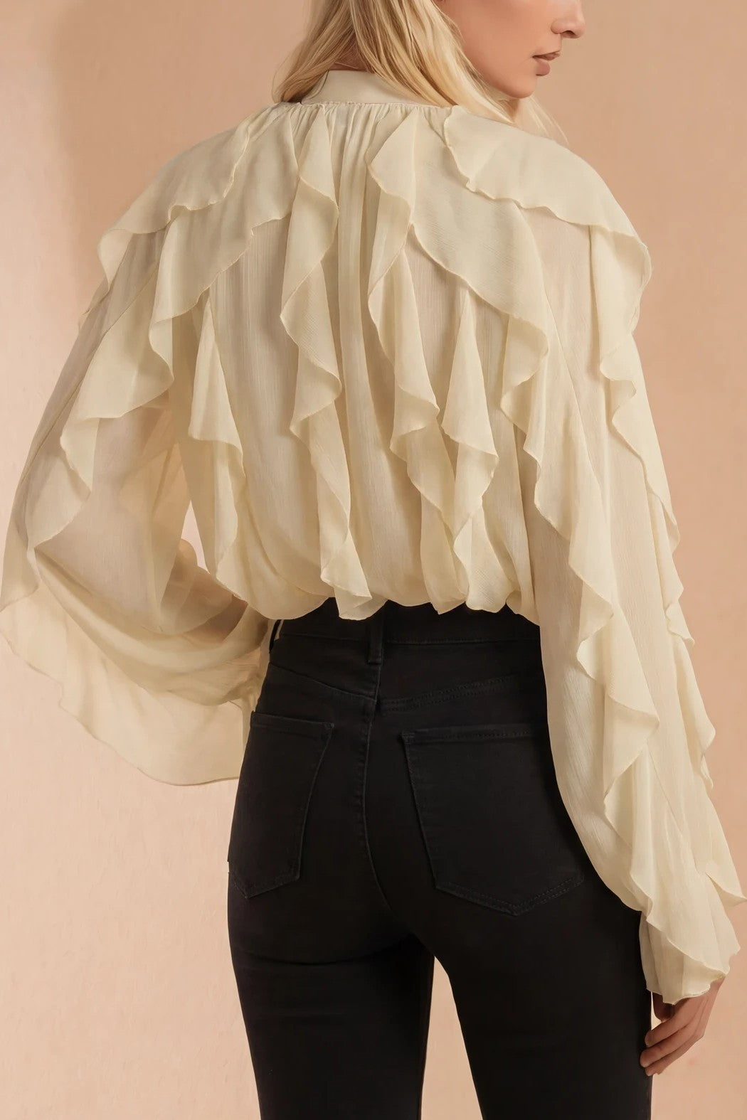 Back view showing the ruffle cascade running from shoulder to blouson hem