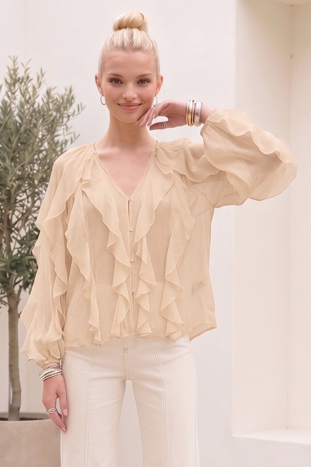 Front view of the cream ruffle blouse with V neckline and pearl buttons