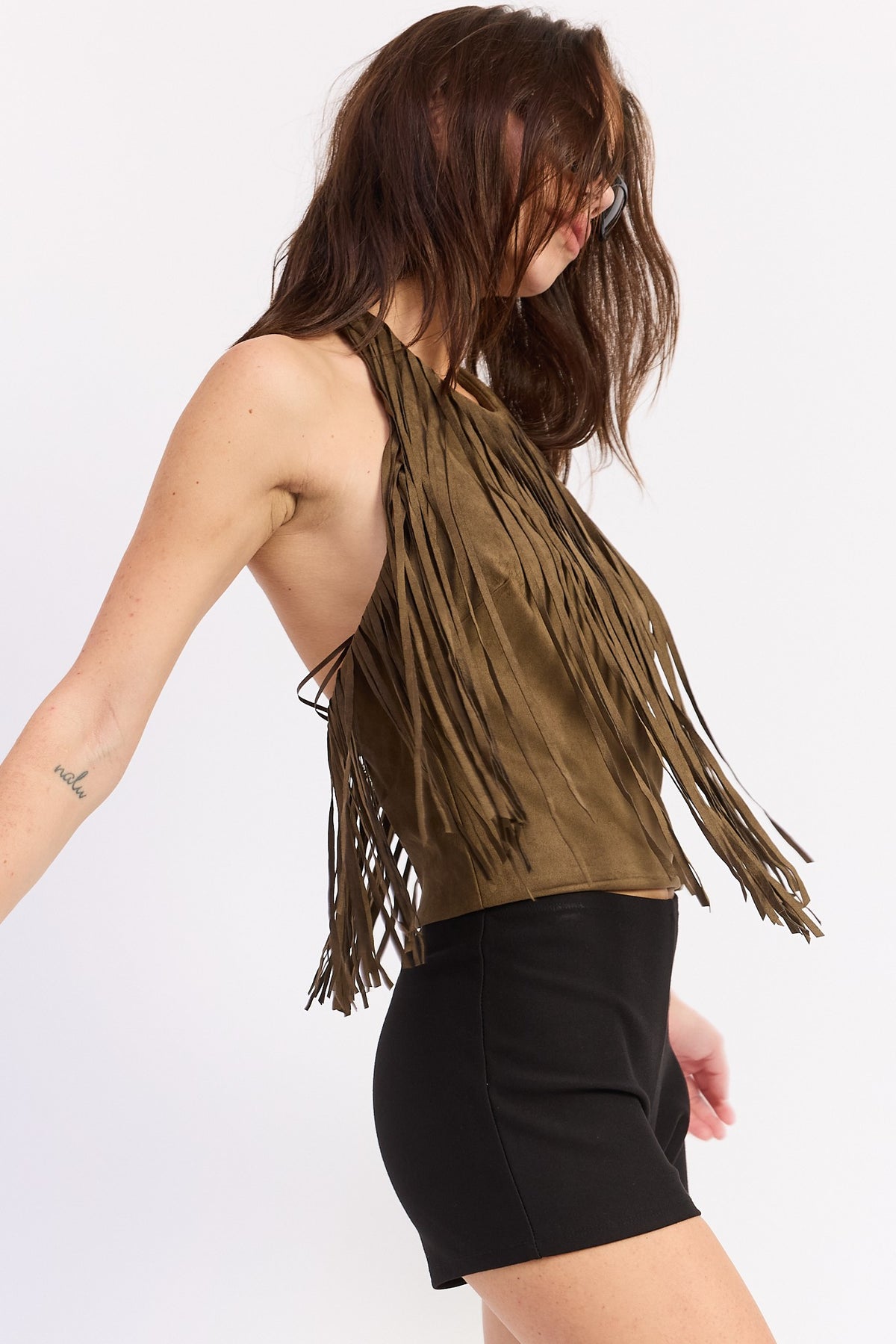 Close view of the suede fringe falling from the chest yoke