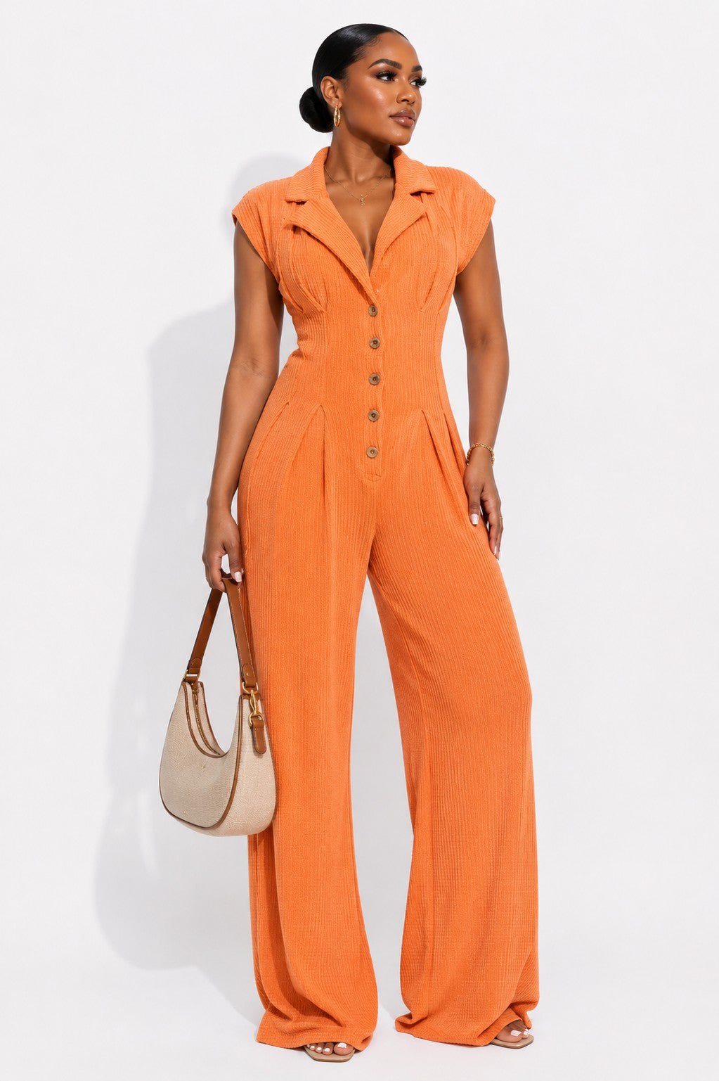 Orange ribbed knit jumpsuit with a lapel collar, button front and wide leg