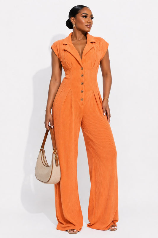 Orange ribbed knit jumpsuit with a lapel collar, button front and wide leg